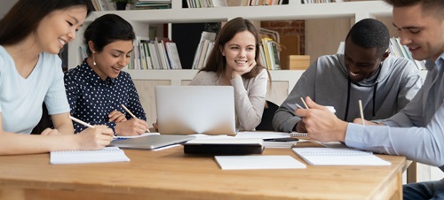 Students study at a table in the library