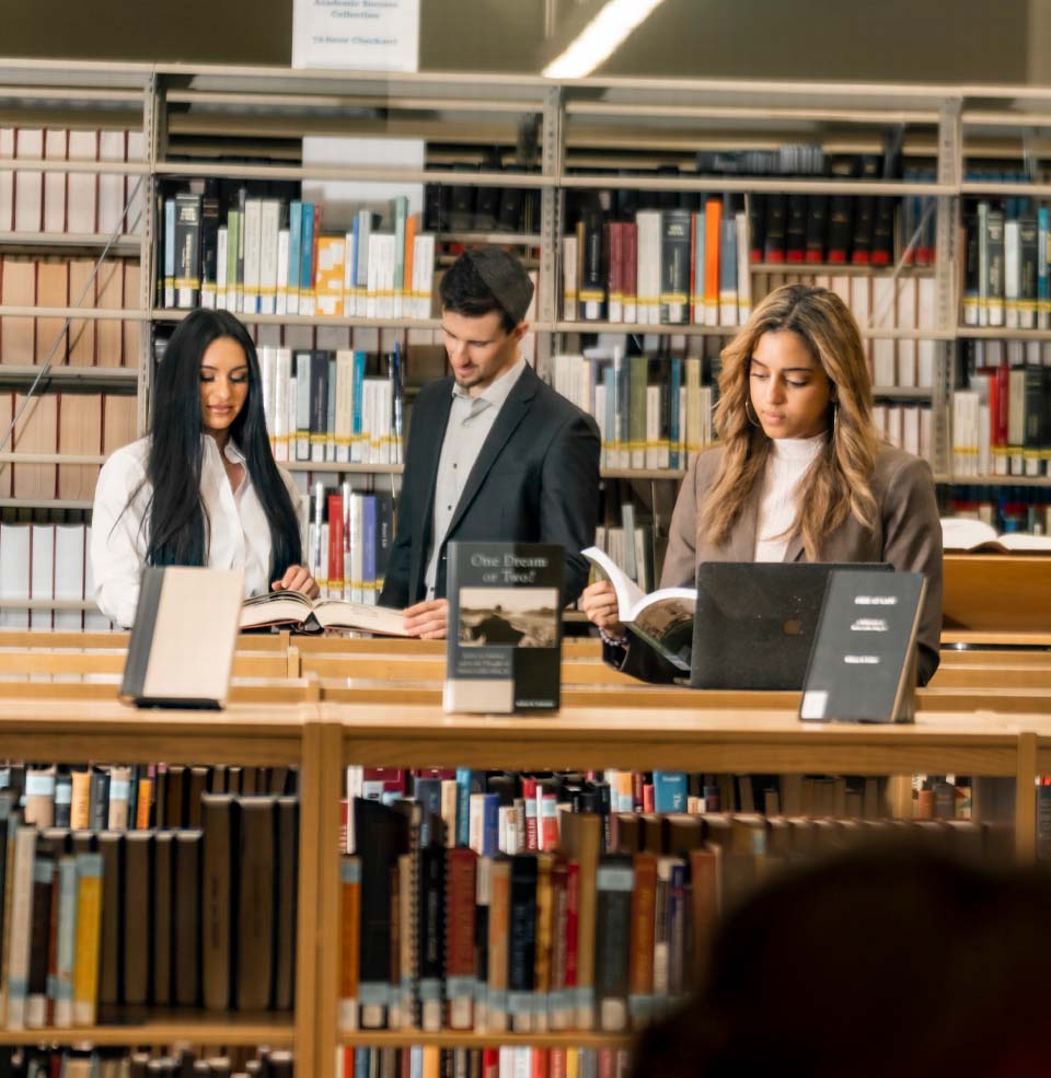  Law Students Looking at Books in Library.