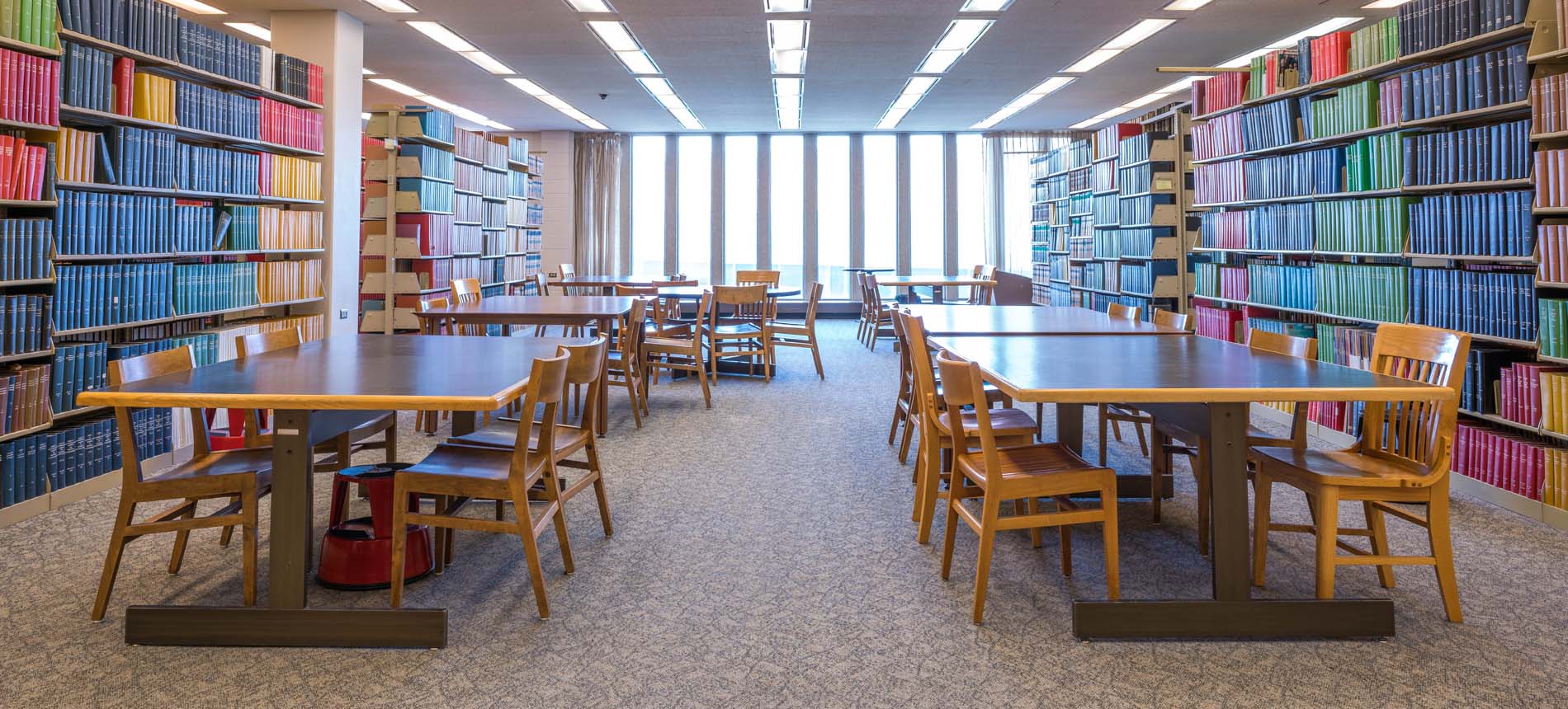 Emptying Tables Between Aisles of Library.