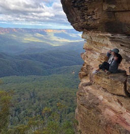 student Sitting on Cliff Enjoying the View