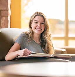 Student with an Open Book Smiling