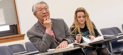 Non-traditional Male Student Listening to Class Lecture.