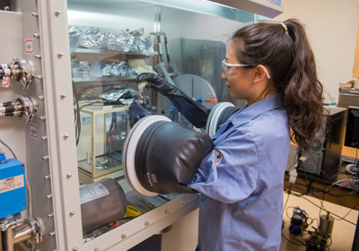A Biochemistry student operating large lab equipment.