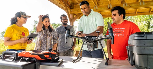 Group of Students Preparing a Drone for Data Collection