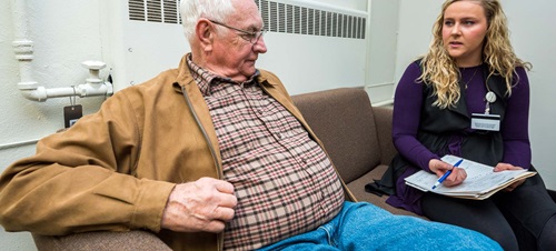 Female Speaking with Elderly Man