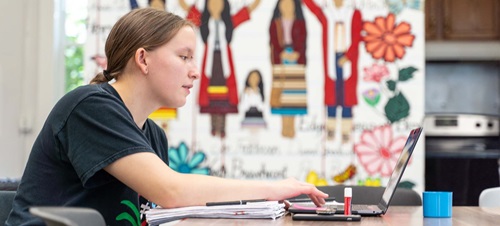 A student working on their laptop.
