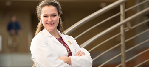 Smiling student in Health Sciences building.