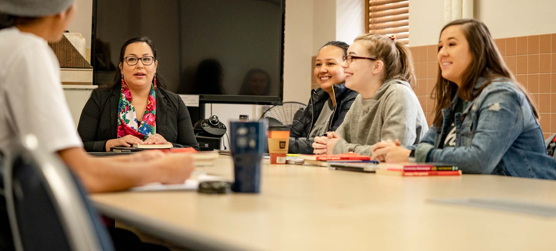 Professor Elise Boxer and students around table seminar discussion