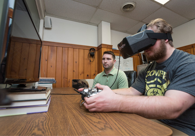 Students Utilizing the Driving/Flight Simulators for Research.