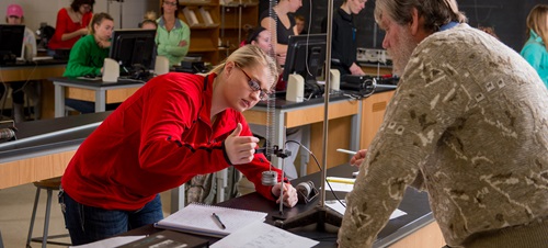 Professor Assisting Student with Lab Assignment.