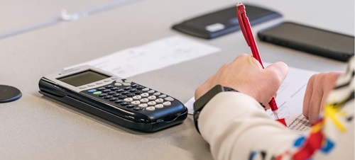 Student Working Mathematical Problem with Calculator