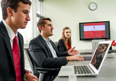 Three Interns in a Board Room Having a Discussion.