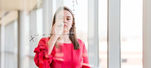 Female Student Drawing a Line Graph.