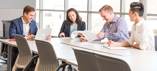 Four Young Professionals Sitting Around a Table.