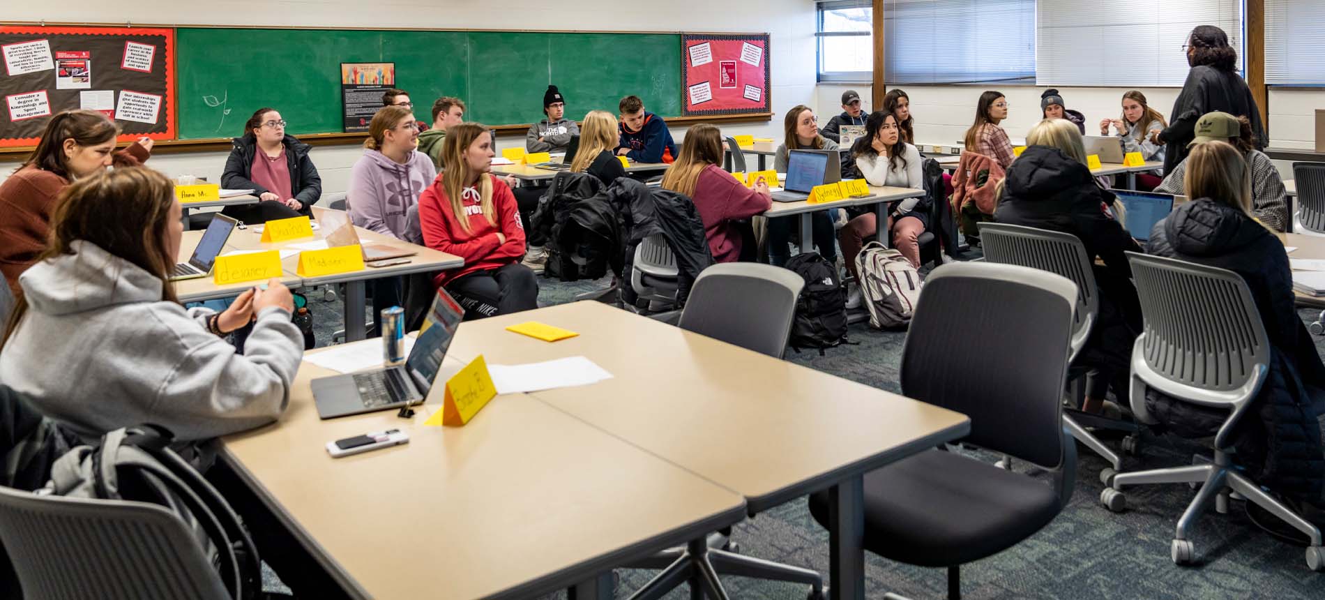 Teacher Lecturing to a Class of High School Students.