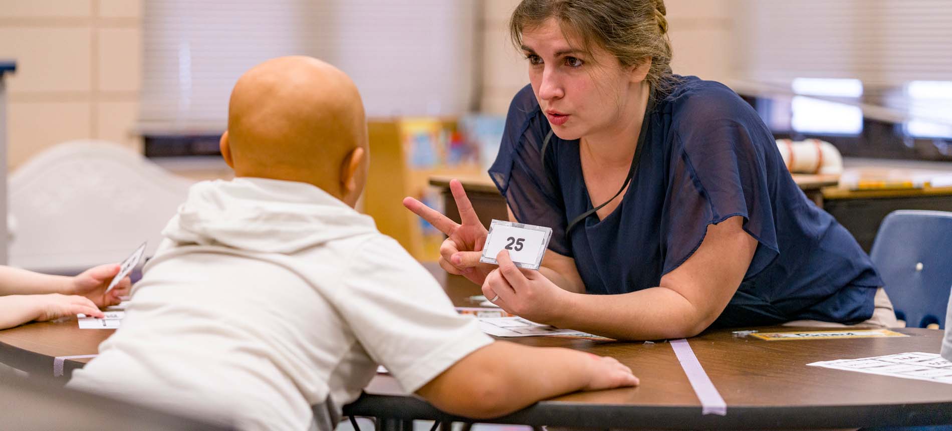 Teacher working with a young student.