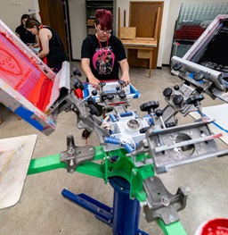 Student learns the screen printing process