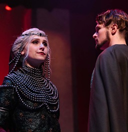 Students performing theatre on stage.