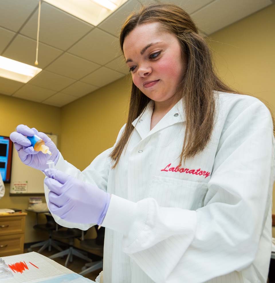 Student in White Lab Coat Preparing Lab Results