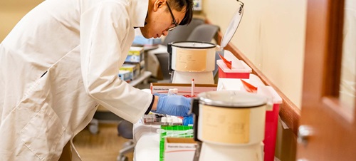Student in White Lab Coat Working in a Medical Lab