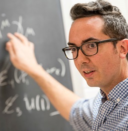 Person writing on a chalkboard