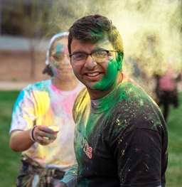 Students Throwing Colored Powder at Holi Event