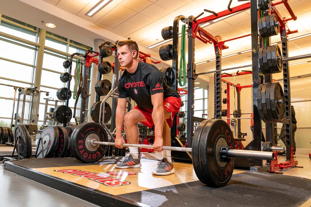 Male Lifting Weights at the Wellness Center
