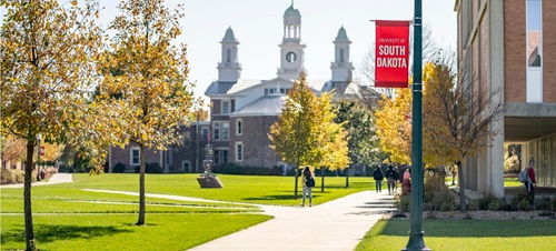 Students Walking Outdoors on Campus by I.D. Weeks Library