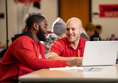 Athlete working in the athlete success center in the library
