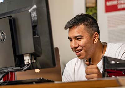 Student looking at computer.