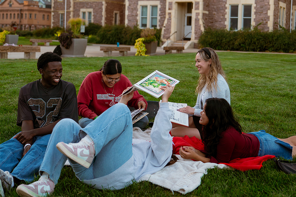 people in a group having a picnic in front of old main