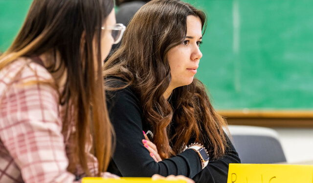 Two students paying attention in class at USD.