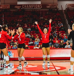 The USD Volleyball team celebrating winning a point.