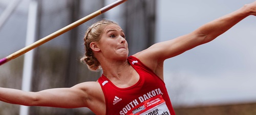 A USD female thrower heaving a javelin.