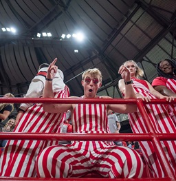 Coyote Crazies cheering at the camera in the football student section.