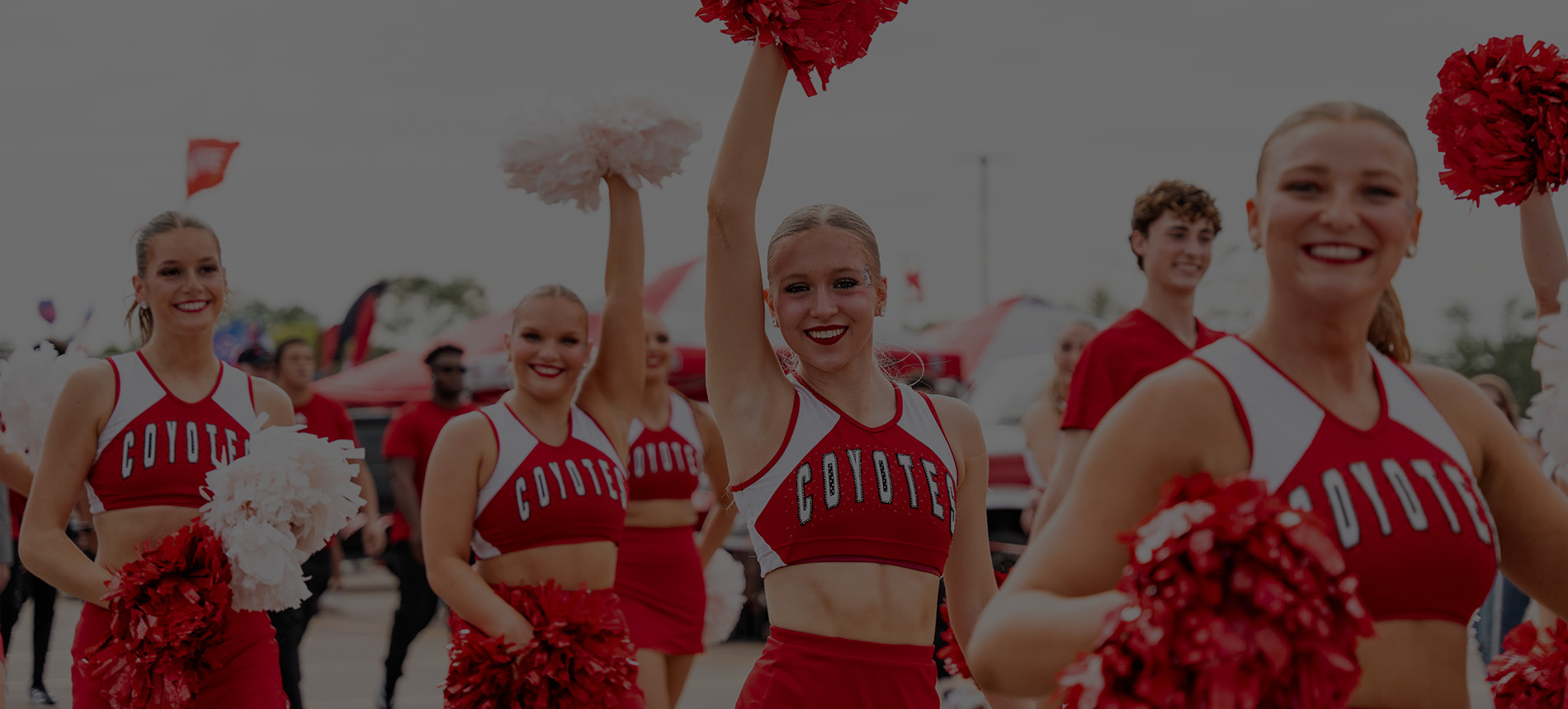 USD Spirit Squad in Dakota Days parade smiling and walking down the street