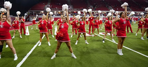 The USD Spirit squad during a cheer at a Football game in the DakotaDome.