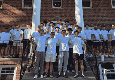 Phi Delta Theta group photo in front of fraternity house. 