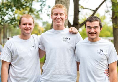 Fraternity students smiling.