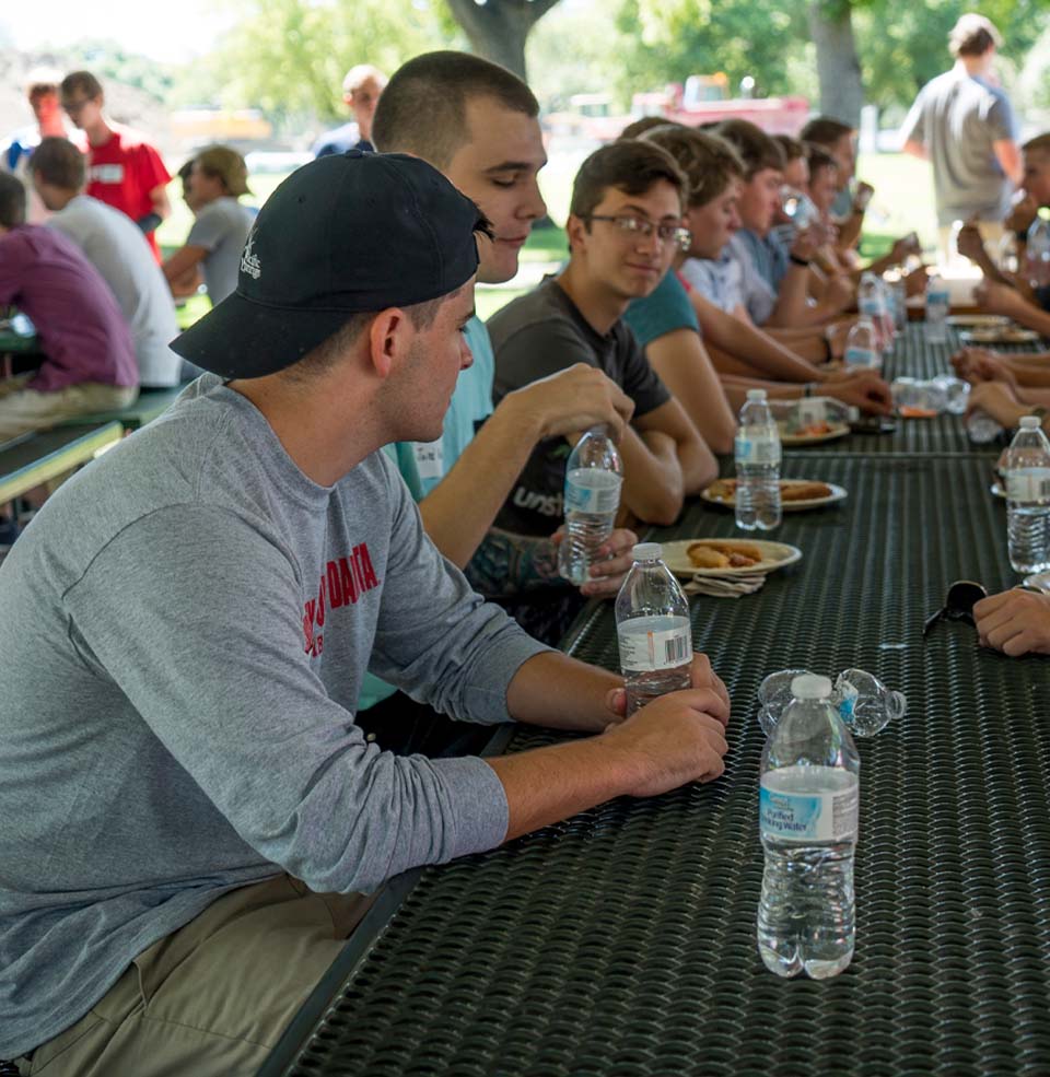 Fraternity students sitting at a table together.