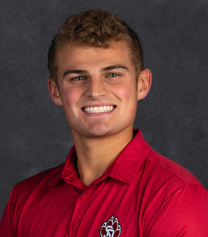 Student success story Hunter Post smiling in a red USD polo.