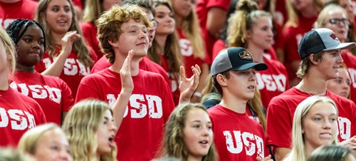 New Students cheering in a crowd.