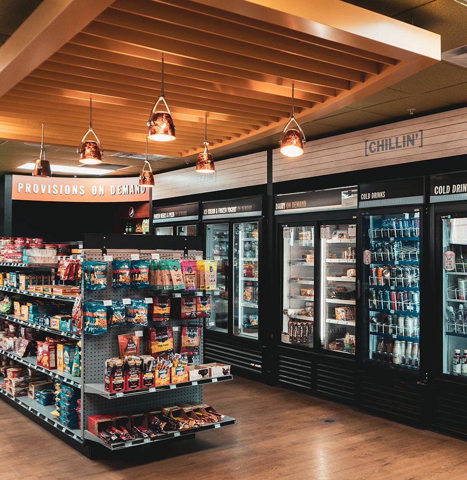 Shelves of food and coolers with drinks in coyote convenience store on campus