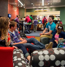Four students sitting in a circle in the MUC lounge pit.
