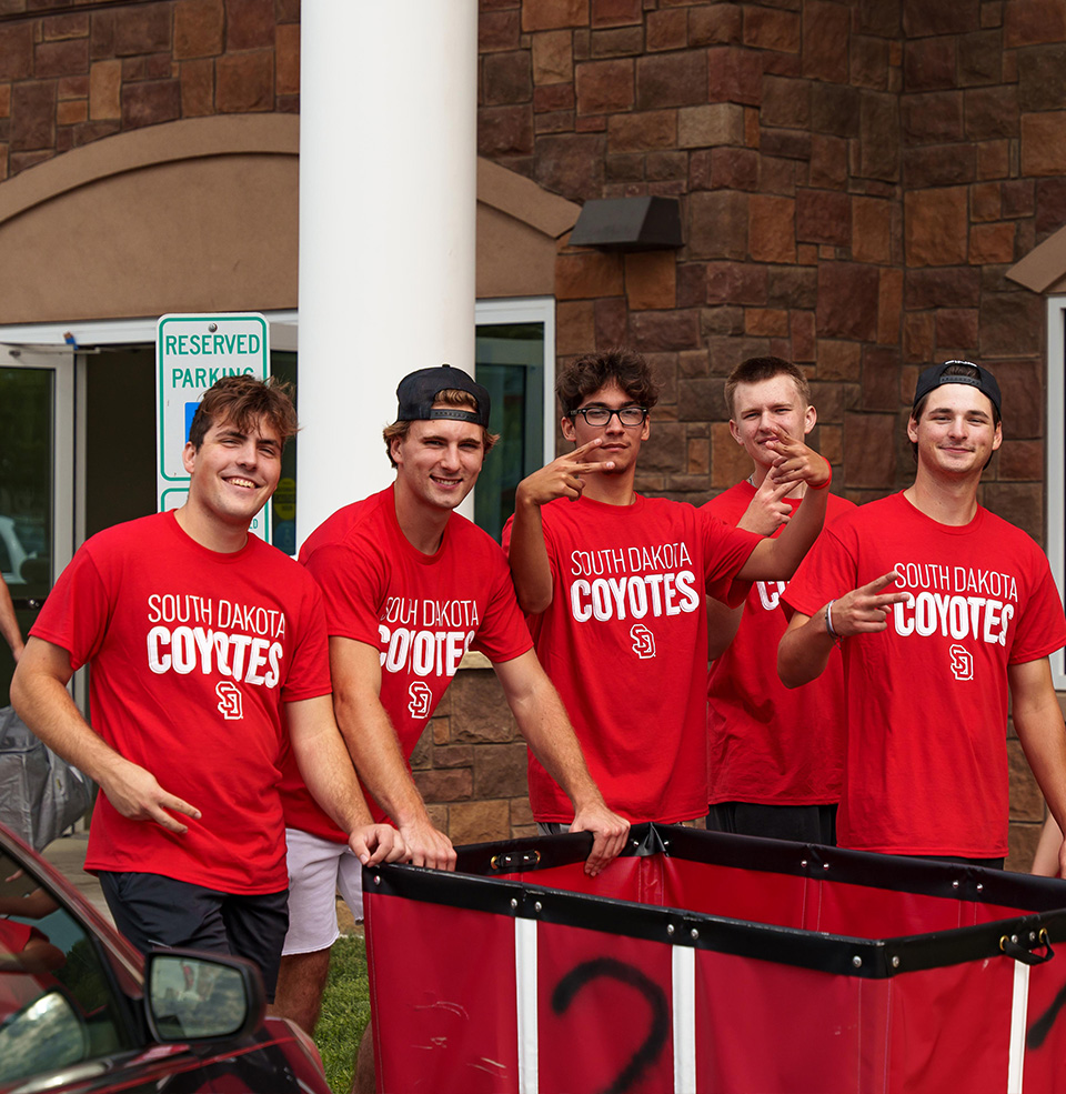 Group of students with a moving bin
