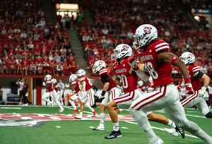 USD football players during a kickoff play running down the field in the DakotaDome.