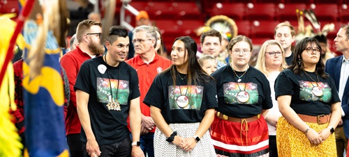 Wacipi attendees and celebrators standing in line awaiting the event start.