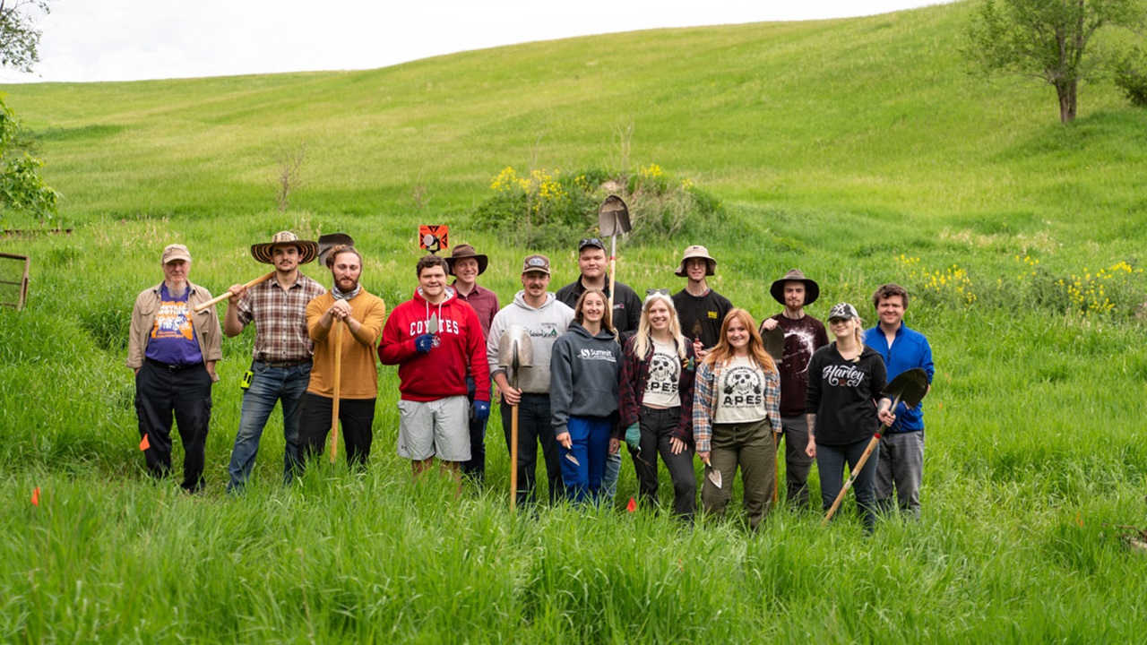 The summer 2022 Susan Tuve Archaeology Field School group of students and Tony Krus standing together for the photo. The summer 2022 Susan Tuve Archaeology Field School group of students and Tony Krus standing together for the photo.