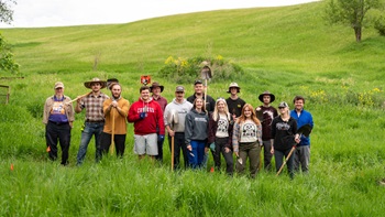 The summer 2022 Susan Tuve Archaeology Field School group of students and Tony Krus standing together for the photo.