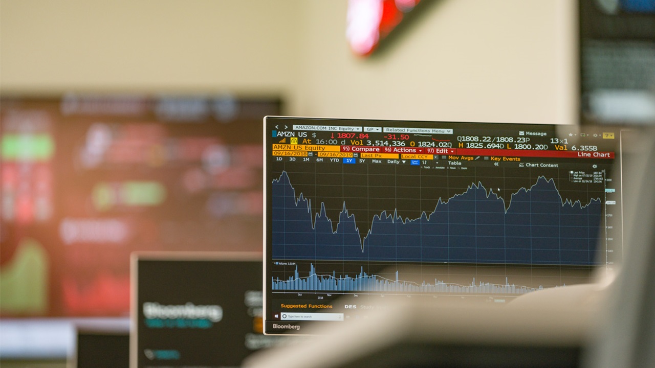 A photo of computer screens with business analytics charts and information.